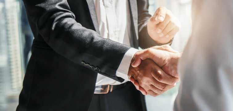 a close-up of men shaking hands