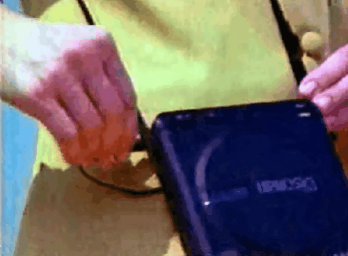a person holding a Discman portable CD player 